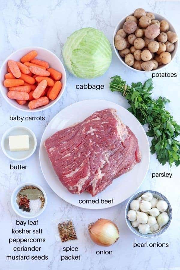 corned beef and cabbage ingredients on a white marble background