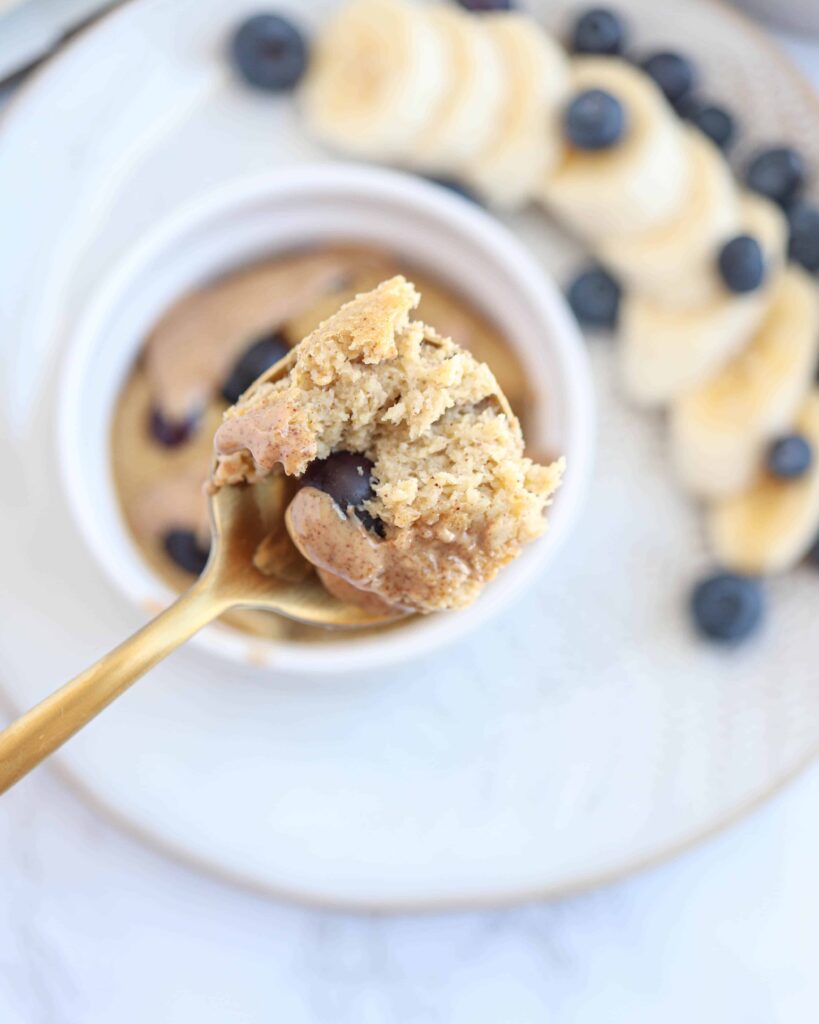 close up of a spoonful of banana baked oats with blueberries