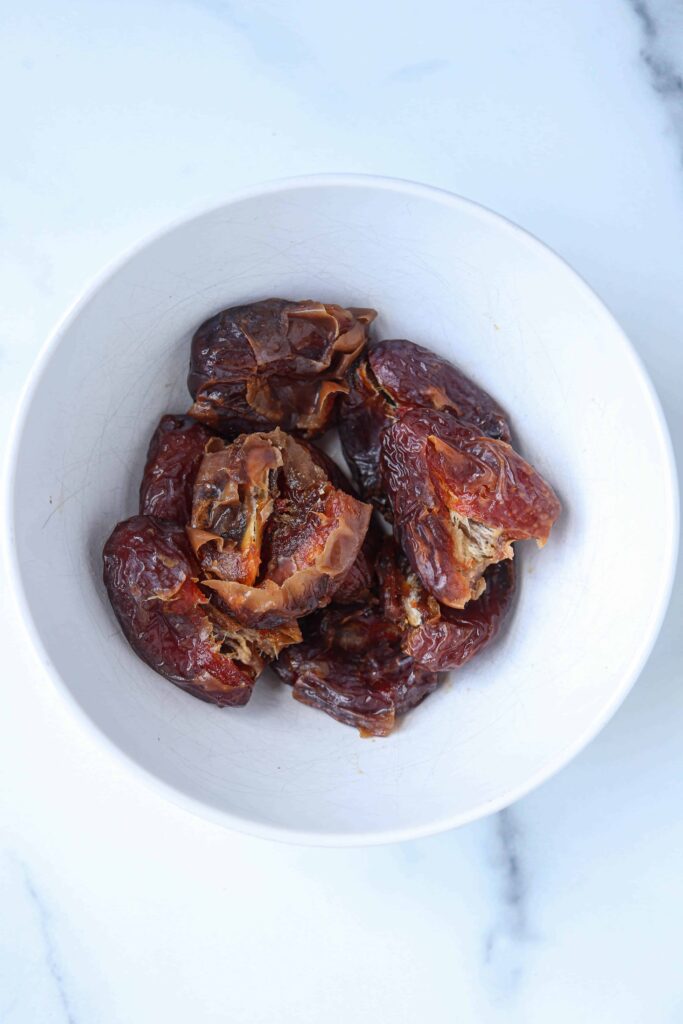 medjool dates in a white bowl.
