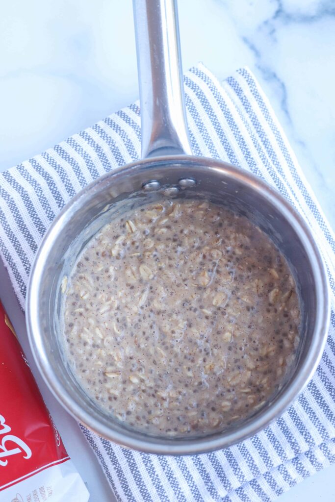 cooked oatmeal with chia in a stainless steel saucepan