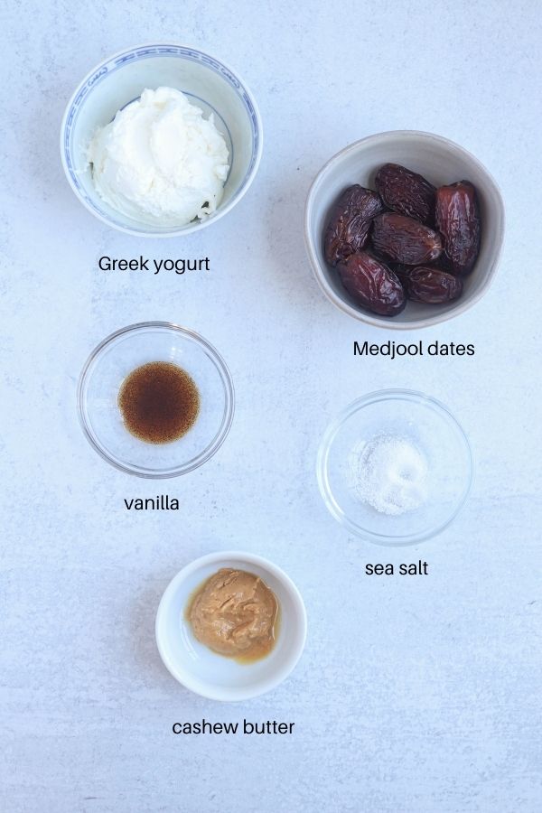 healthy caramel yogurt dip ingredients laid out on a light gray counter