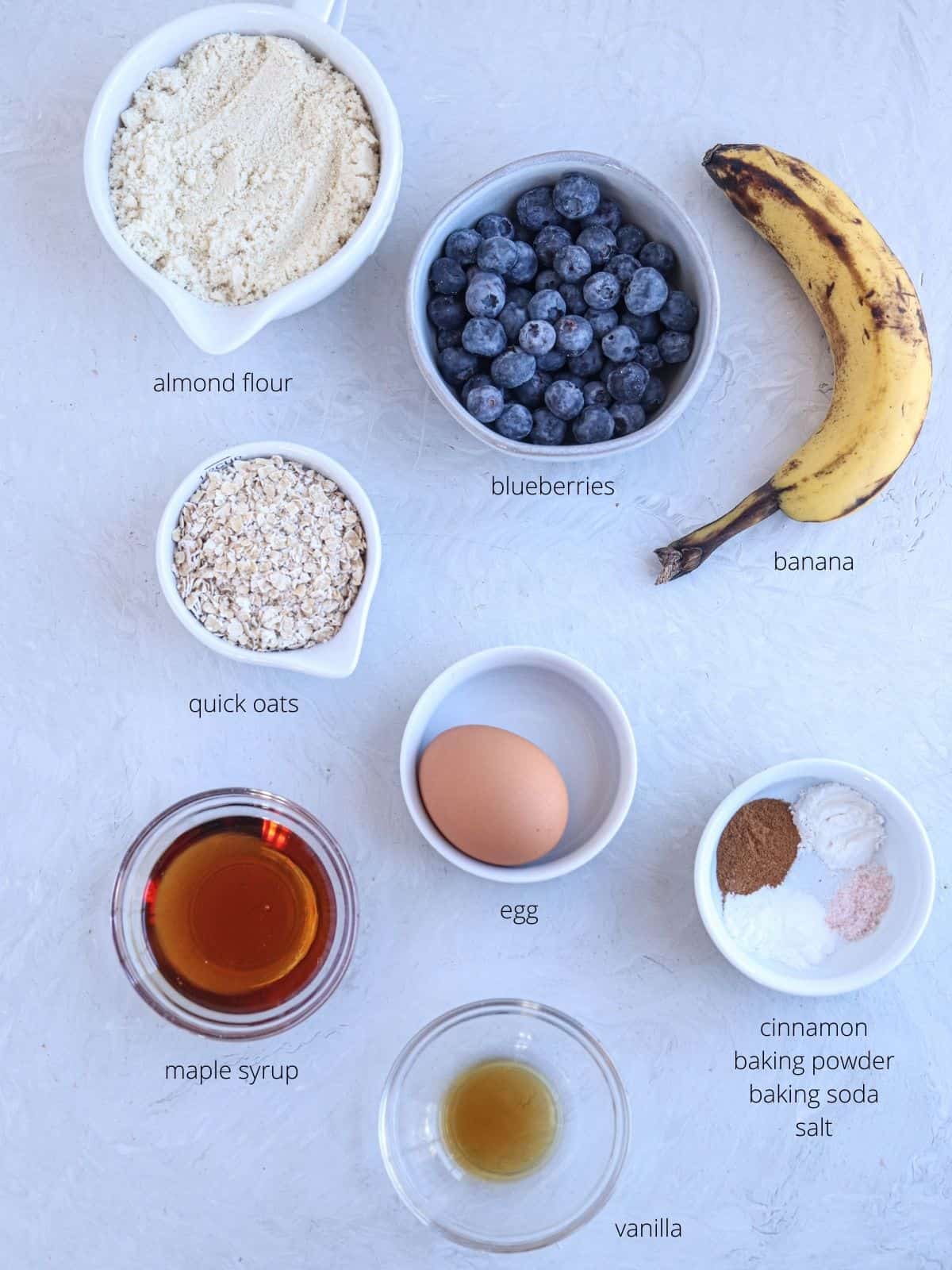 banana blueberry oatmeal muffins ingredients on gray surface.