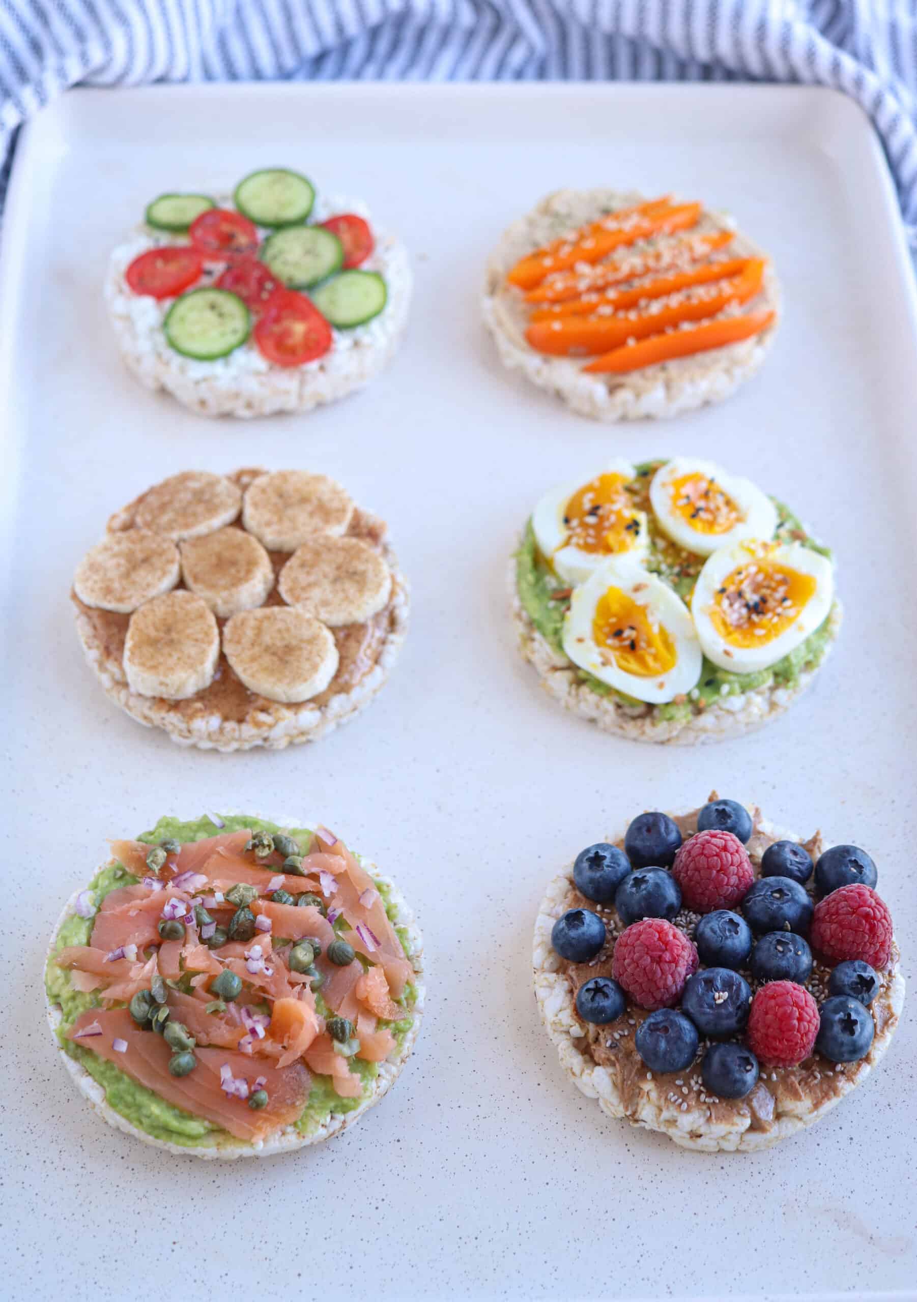 six different kinds of open face sandwiches on round rice cakes, sweet and savory.