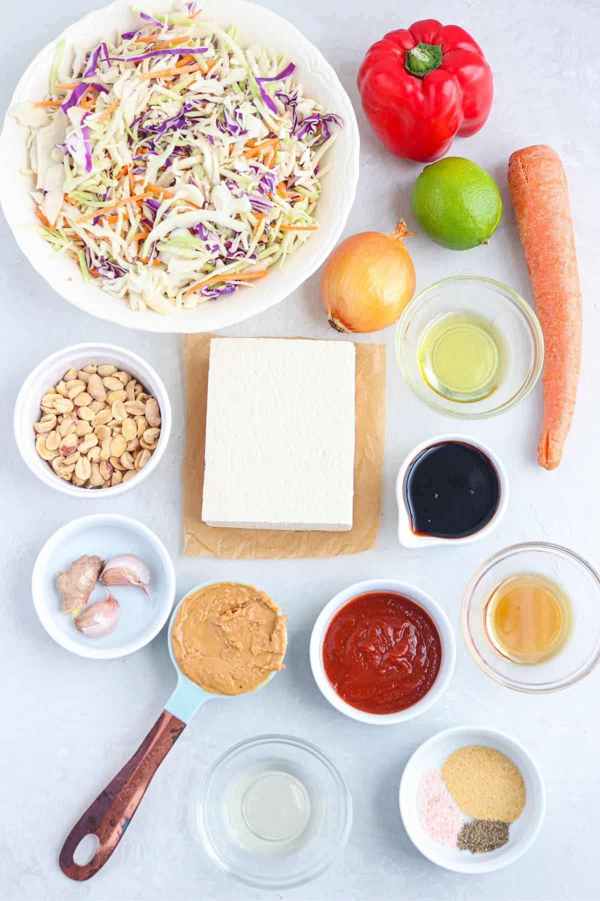 vegan egg roll in a bowl ingredients laid out on a light colored counter in bowls.