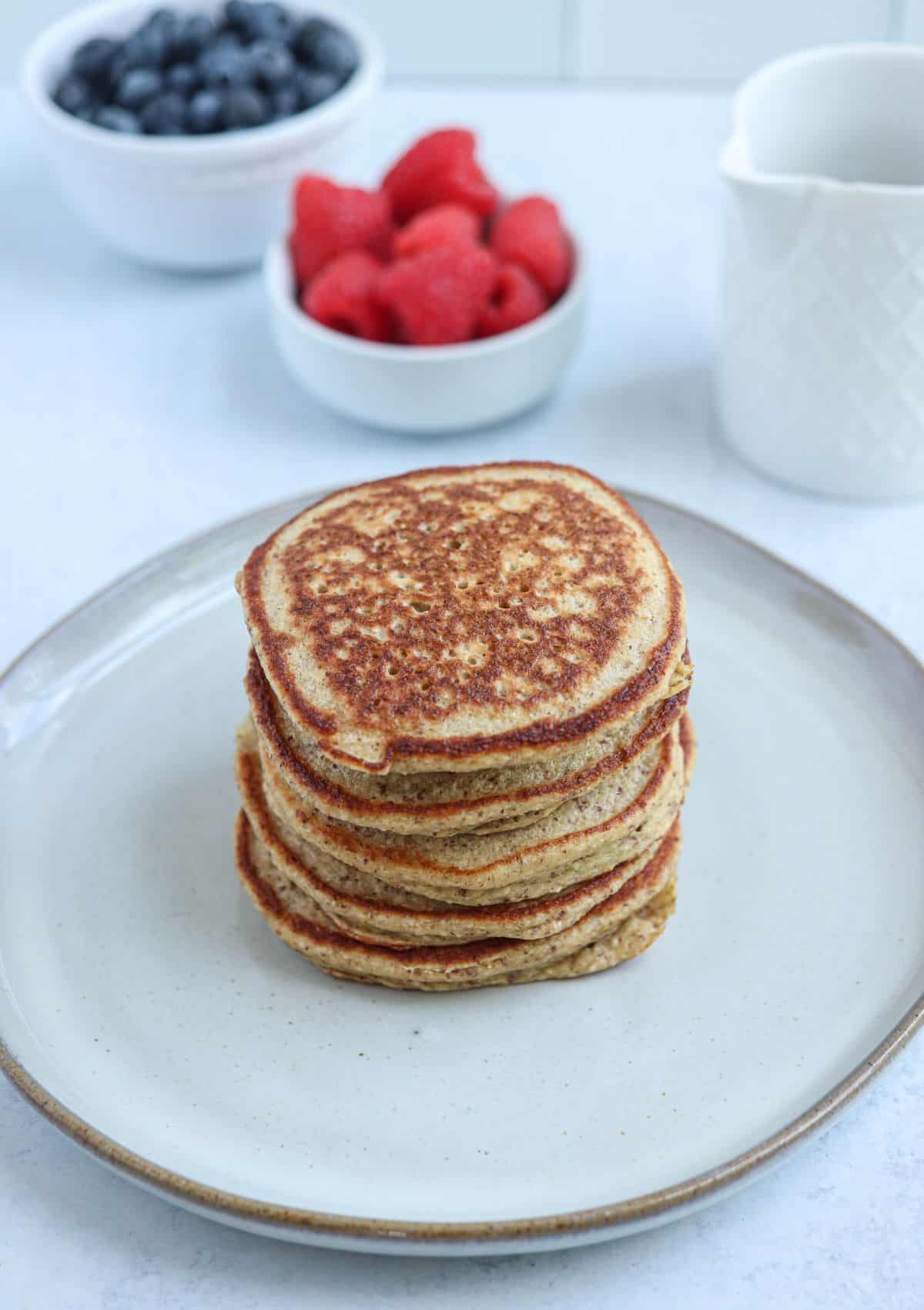 a stack of five protein banana oatmeal pancakes on a gray plate.