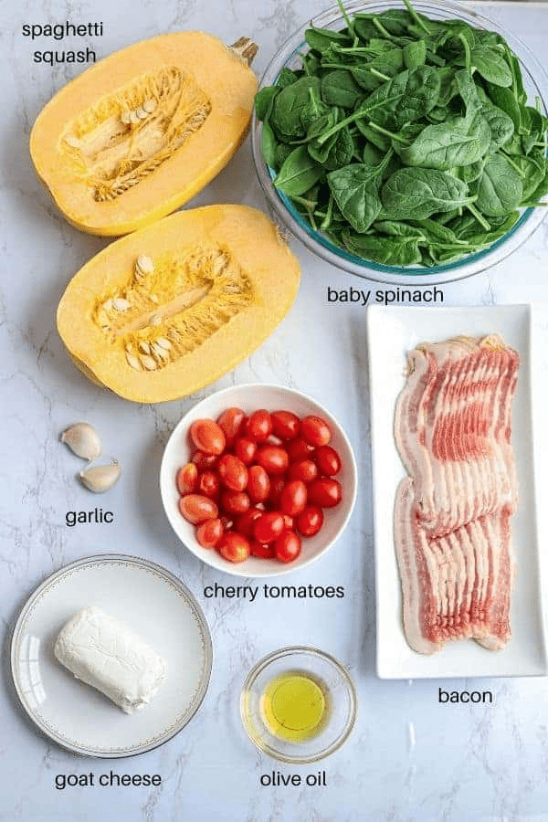 spaghetti squash with spinach and bacon ingredients on shite marble counter with captions. 