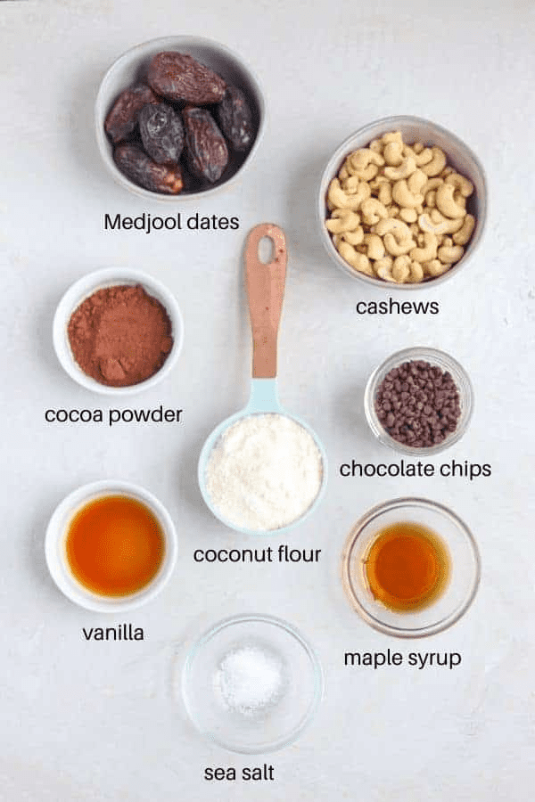 ingredients for making chocolate bliss balls on light gray surface with captions. 