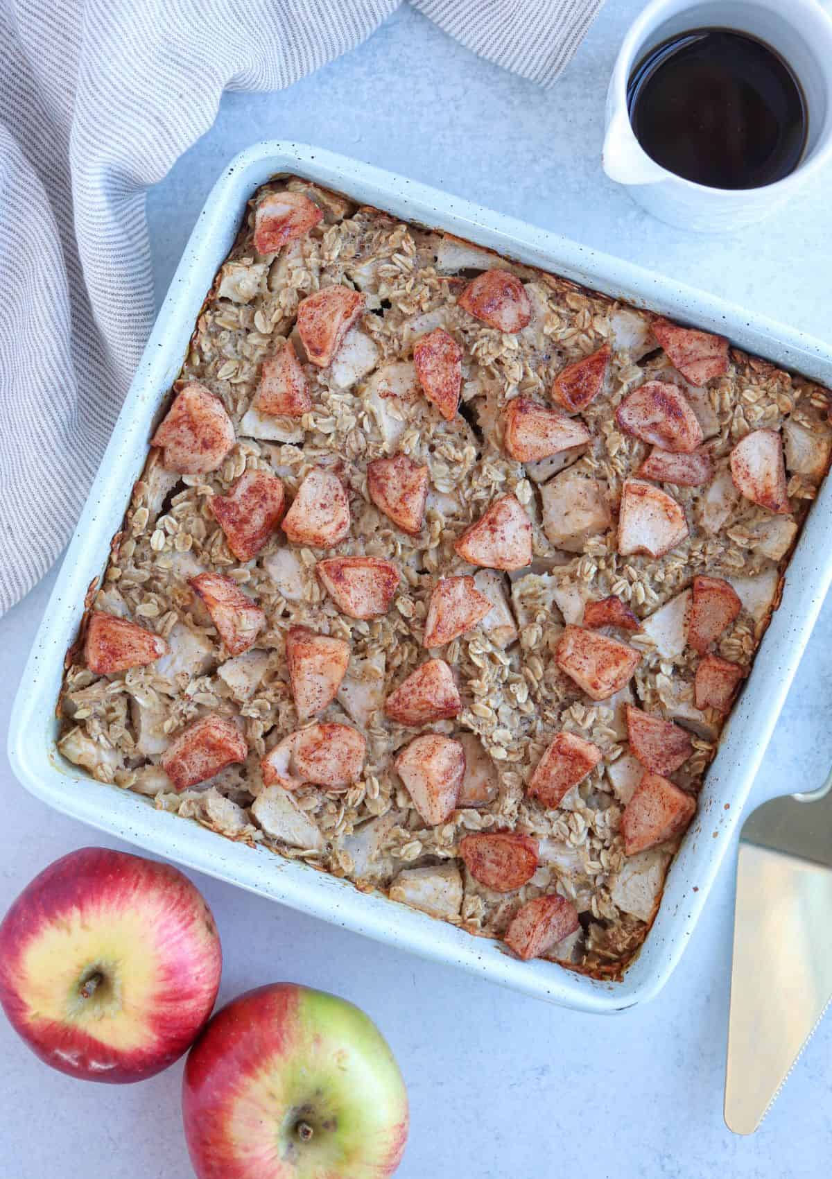 apple pie baked oatmeal in a teal square baking pan, after baking.