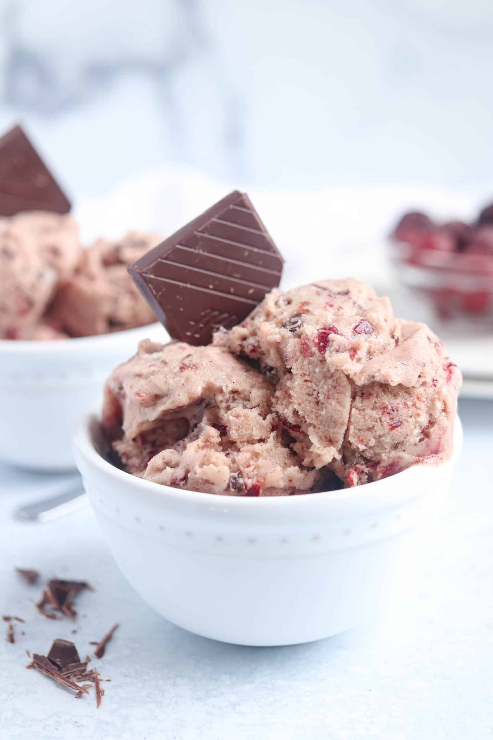 cherry chocolate banana ice cream in a white bowl. 