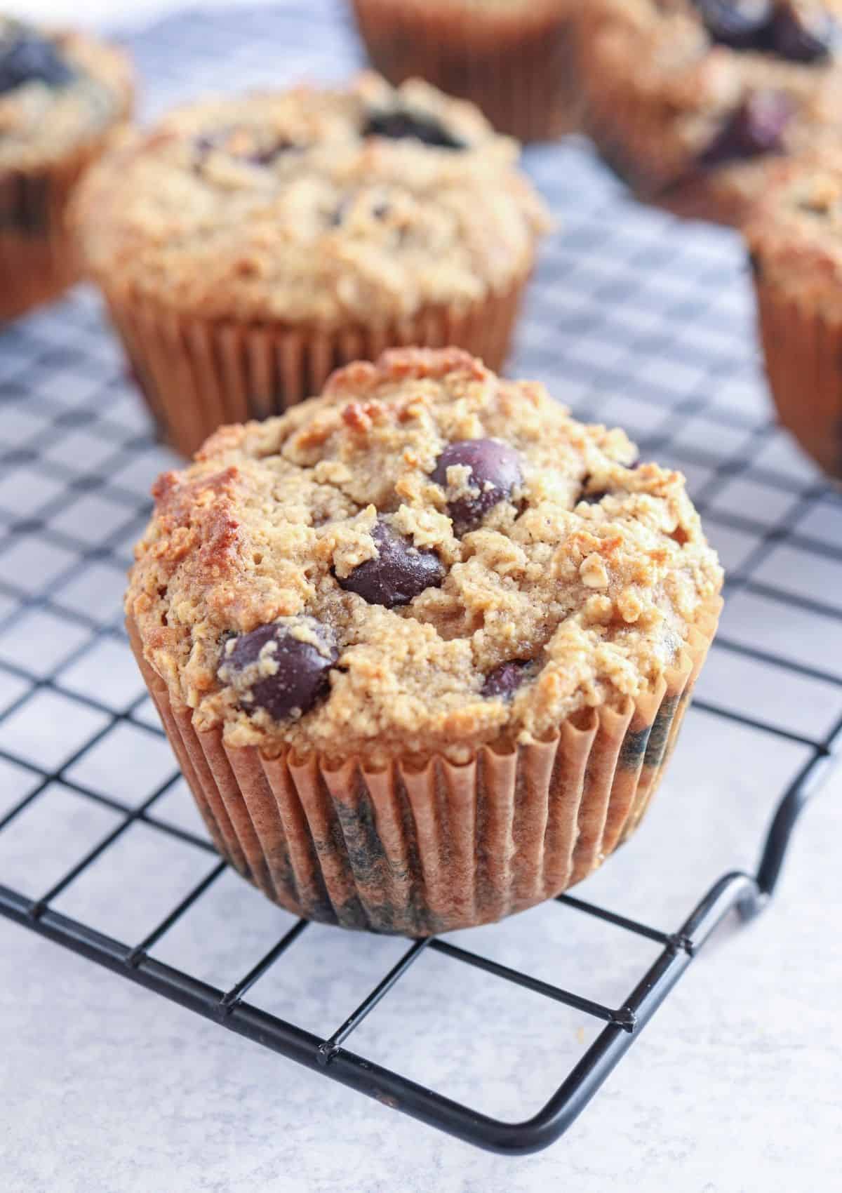 blueberry banana oatmeal muffin on a black cooling rack.