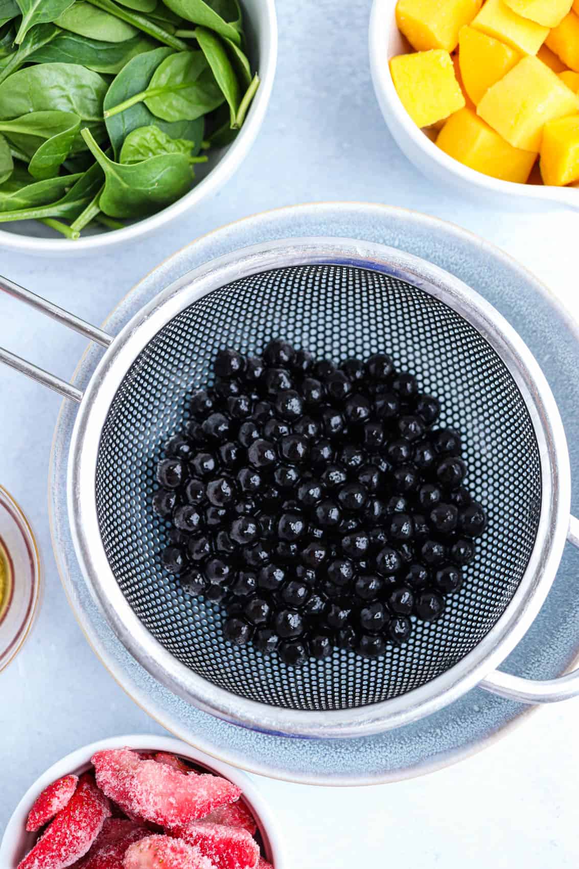 black boba pearls in a sieve.
