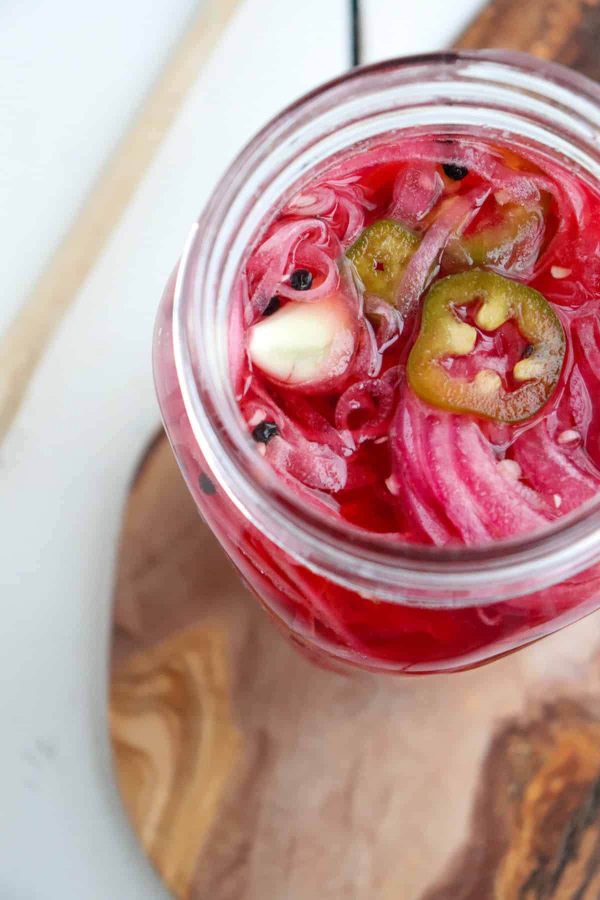 Mexican pickled onions in a glass jar.