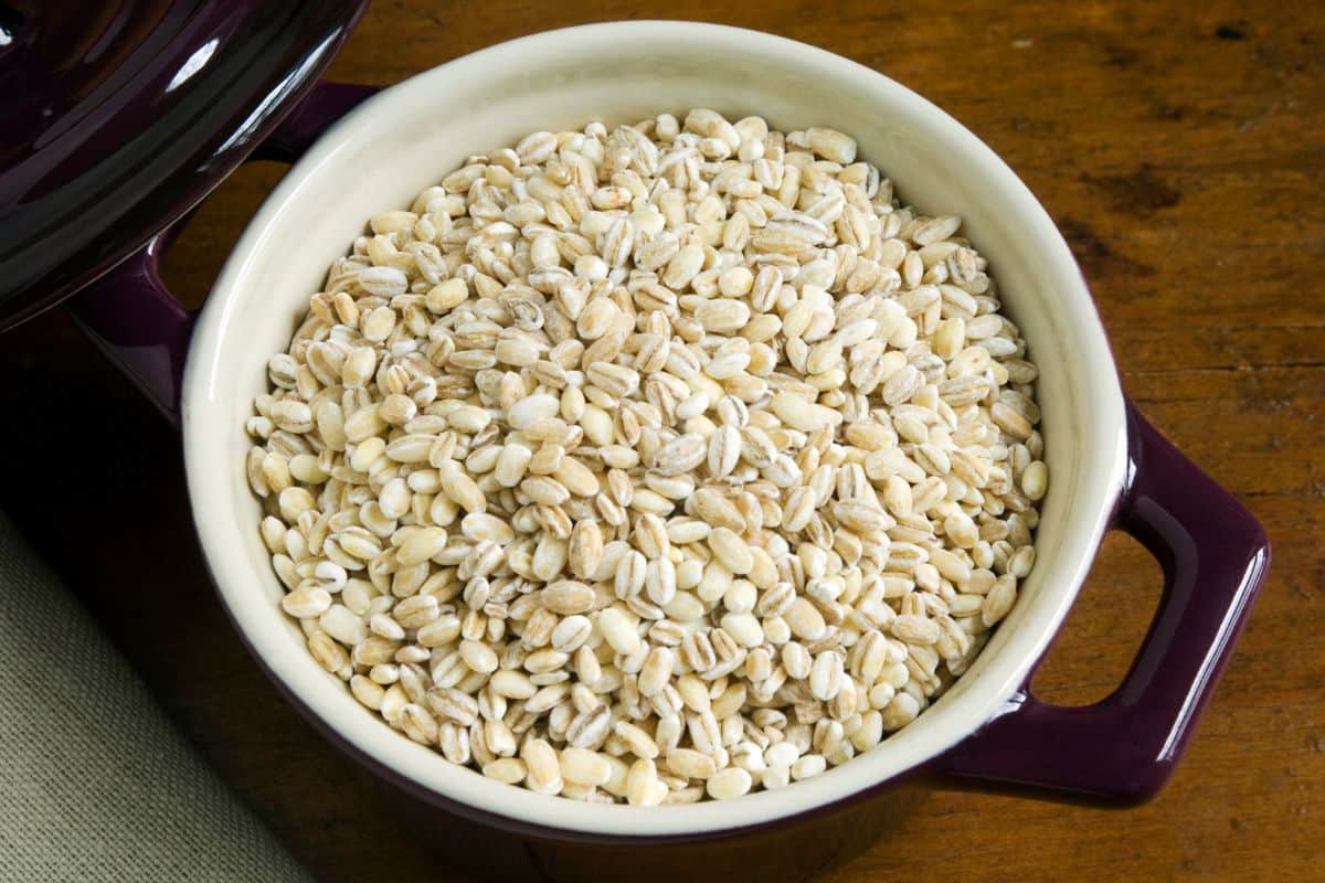 uncooked pearl barley in a ceramic pot.