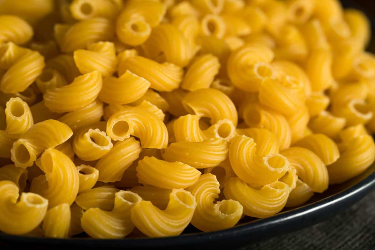 uncooked elbow macaroni pasta.