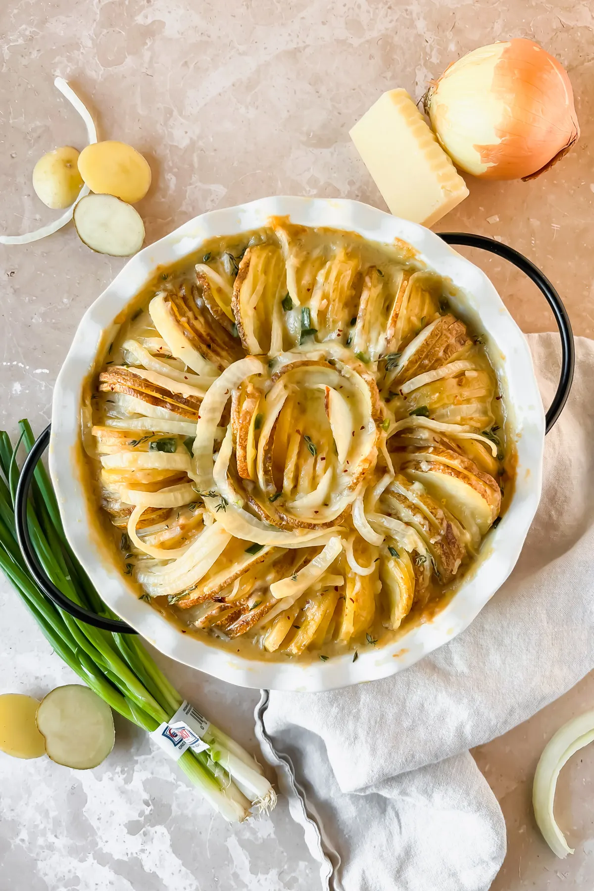 French onion potato slices in a round pie dish.