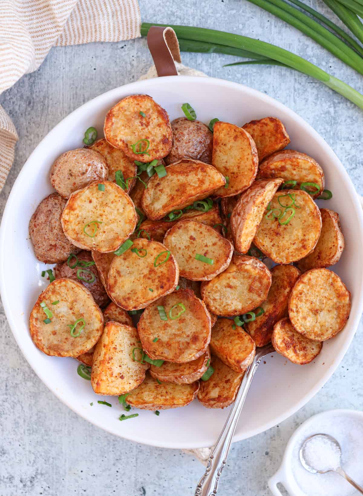 air fried red potato halves in a white serving bowl. 