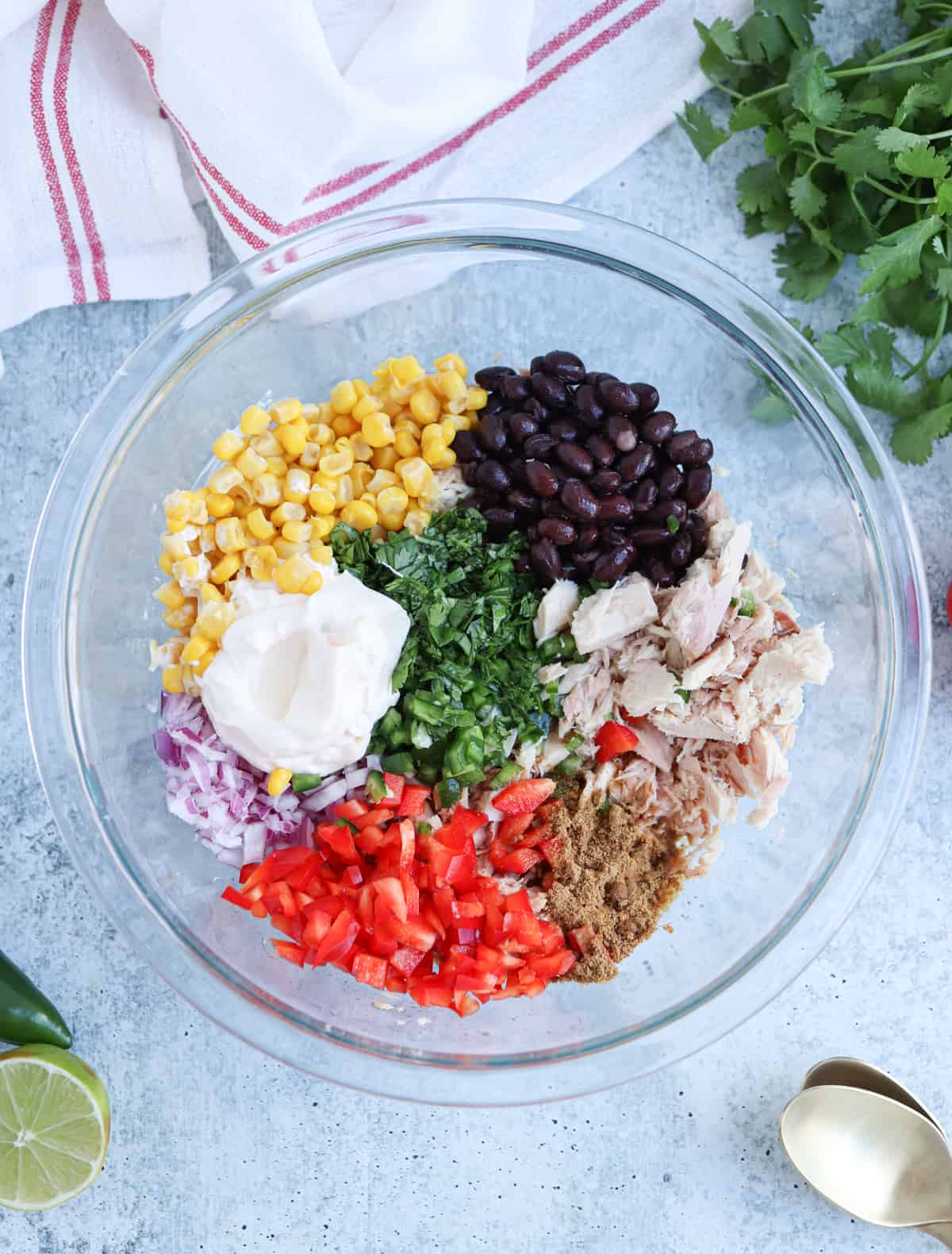 Mexican tuna salad before mixing in a glass bowl.