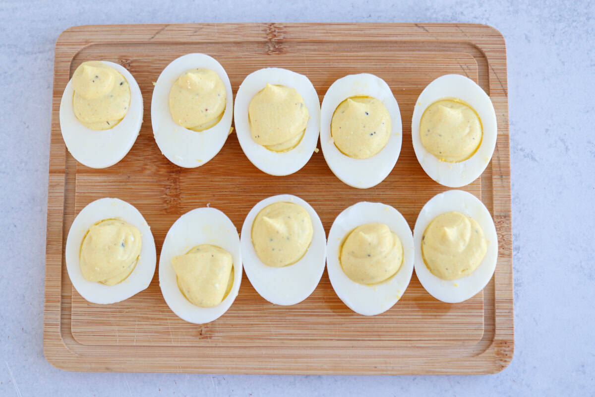 deviled eggs on a wooden board.
